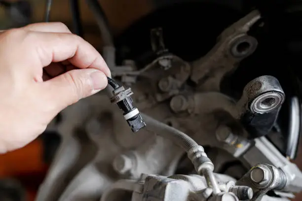 Dirty wheel speed sensor covered with debris causing the ABS warning light to illuminate