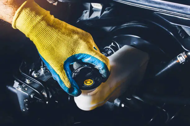 Low brake fluid level in the brake fluid reservoir causing the ABS and brake warning lights to turn on