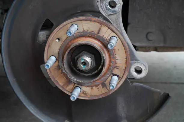 Worn wheel bearing and hub assembly affecting ABS wheel speed sensor performance and triggering the ABS warning light