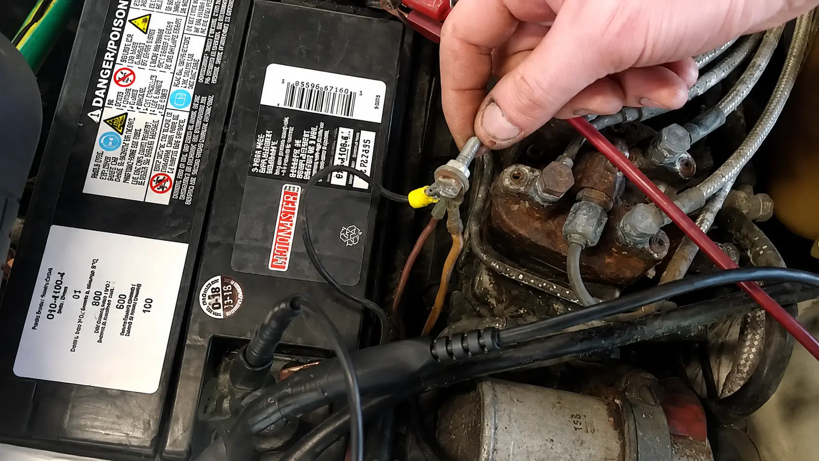 Damaged battery wiring and poor ground connection causing charging system failure and battery warning light