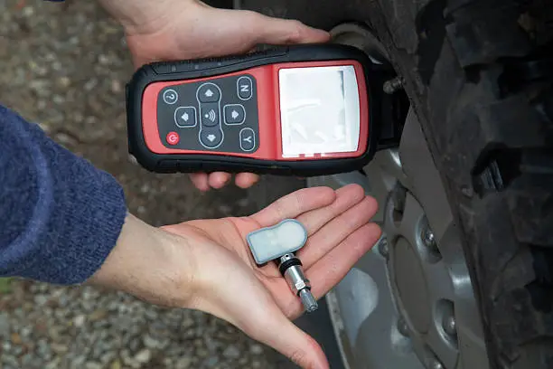 Worn TPMS sensor with a dead internal battery causing a tire pressure warning light