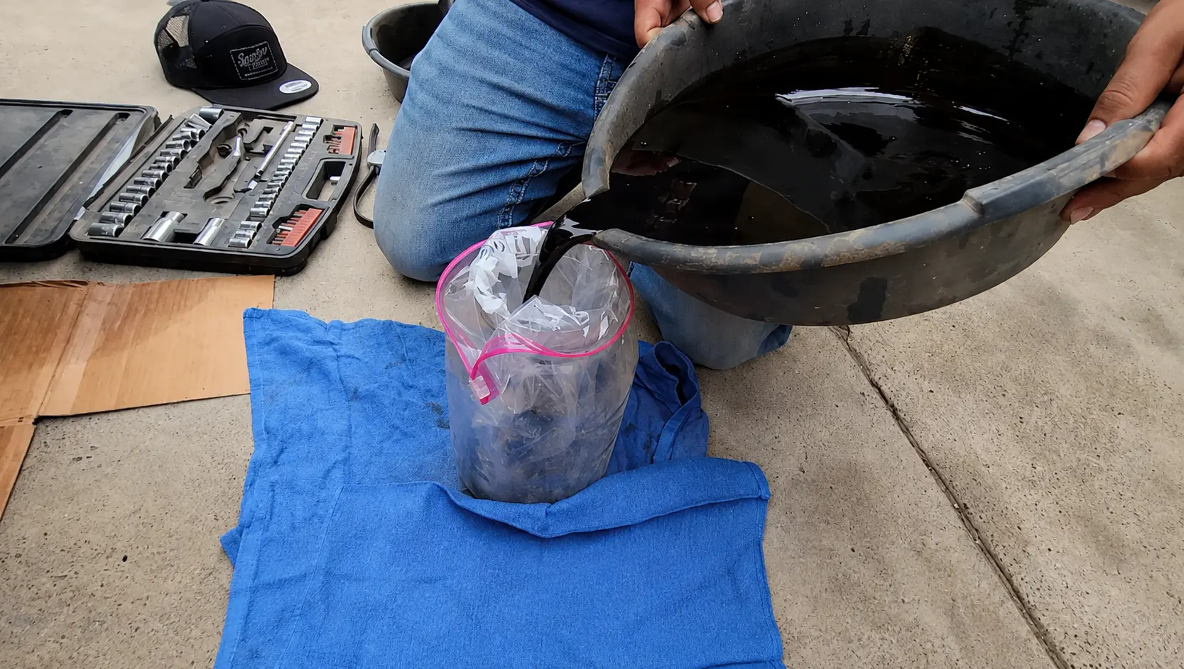 Dirty engine oil and heavy engine sludge buildup inside a vehicle engine causing reduced oil circulation and low oil pressure.