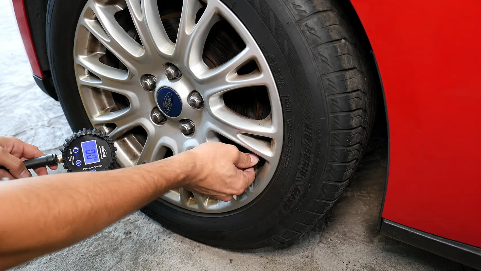 Faulty TPMS sensor removed from a car wheel during tire pressure monitoring system repair.