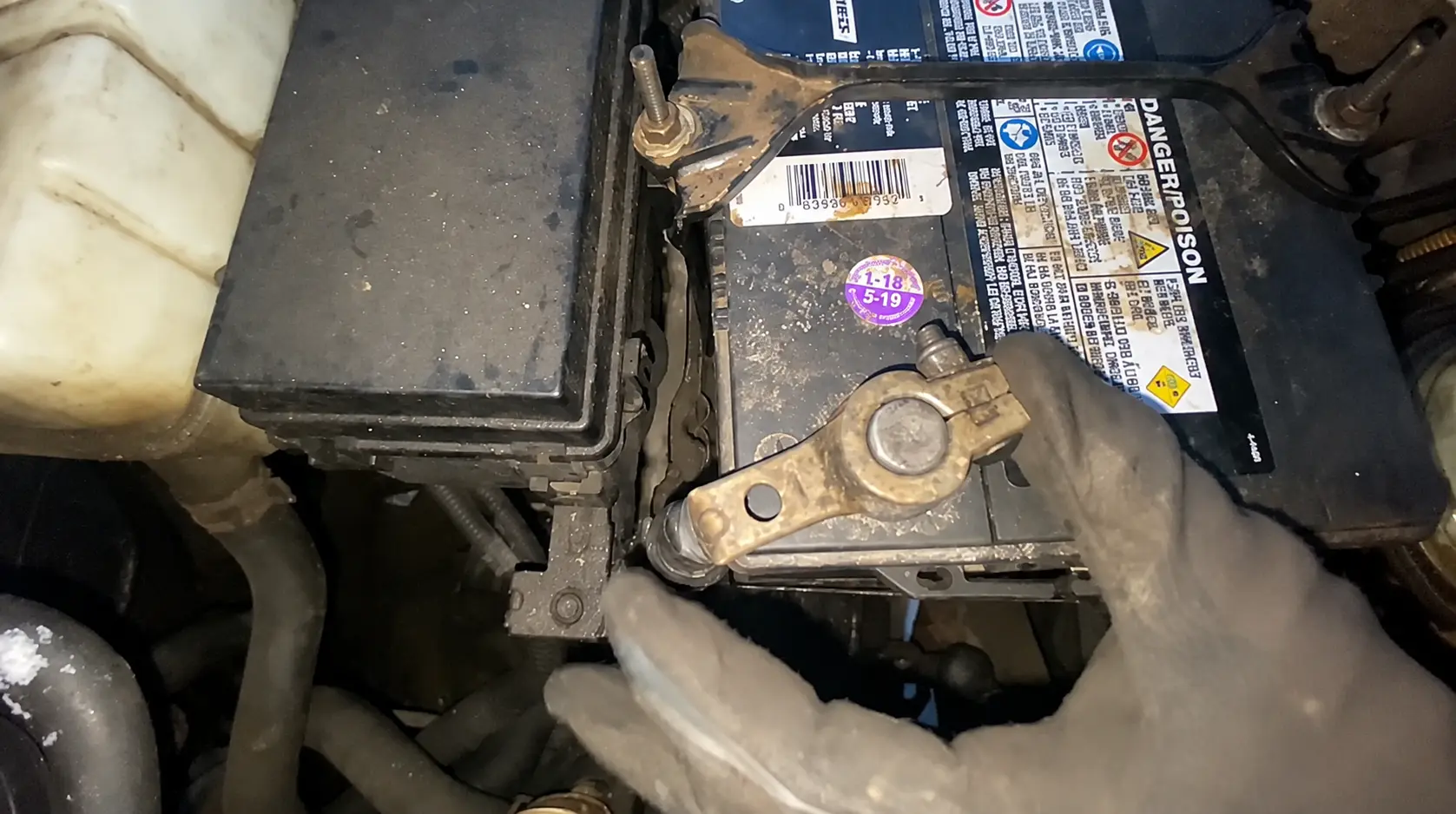 Loose and corroded car battery terminal causing charging system problems and battery warning light