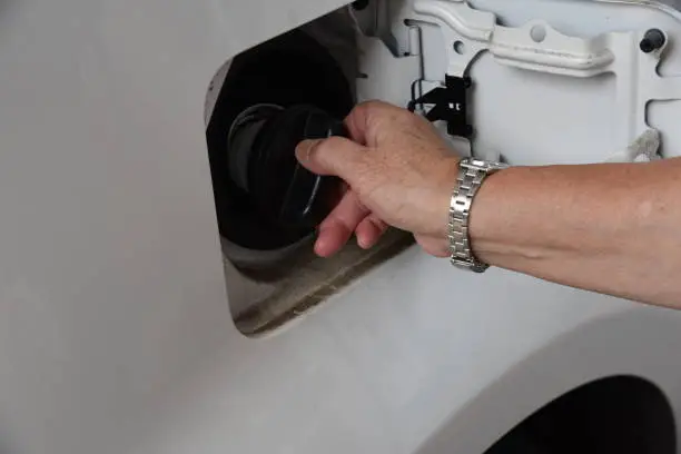 Tightening or replacing a loose gas cap to help clear an EVAP-related check engine light warning.