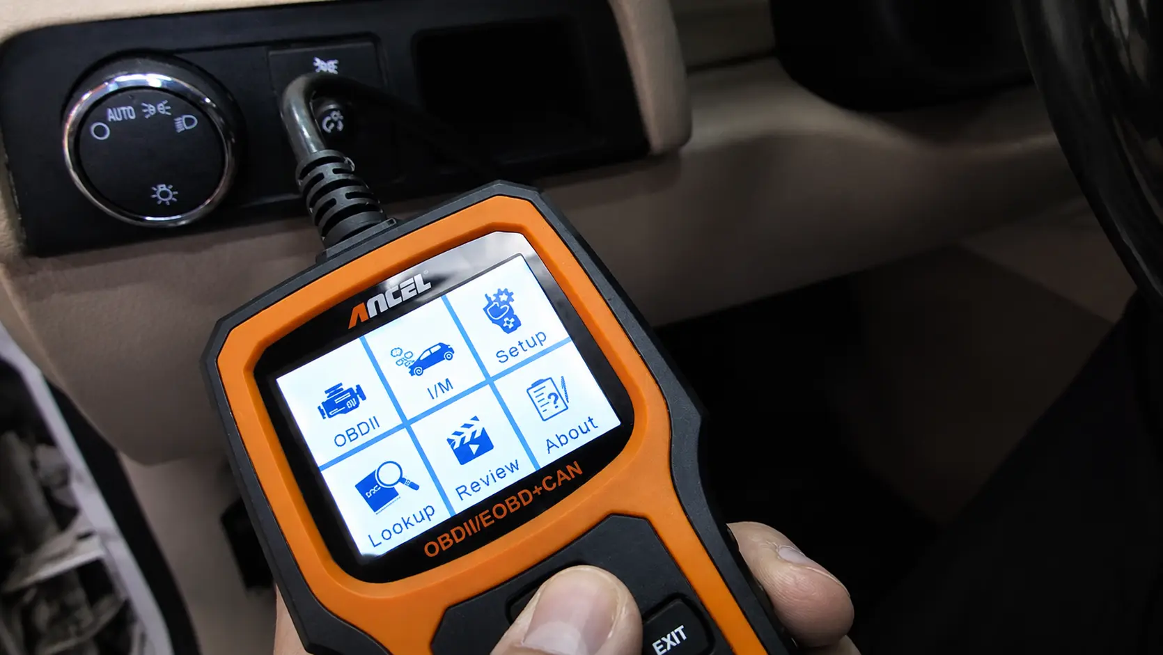 Mechanic using an OBD-II scanner to diagnose and reset the check engine light by reading diagnostic trouble codes (DTCs).